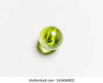 One Green Glass Ball With Caustic On A White Background