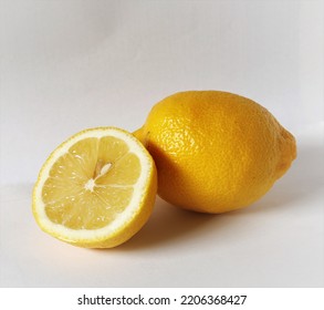 One And A Half Bright Yellow Juicy Lemon On The White Background, Healthy Vitamin Food For Vegetarians And All People