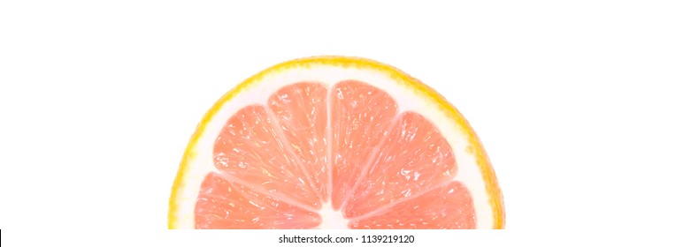 One Half Of A Ripe Lemon With A Pink Flesh On A White Background.