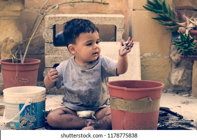 One And A Half Year Old Baby Boy Playing With Dirt