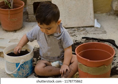 One And A Half Year Old Baby Boy Playing With Dirt