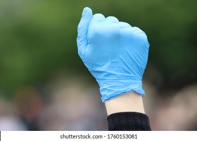 One Hand In A Blue Surgical Glove Raised In A Fist At A Black Lives Matter Protest In Edinburgh Scotland