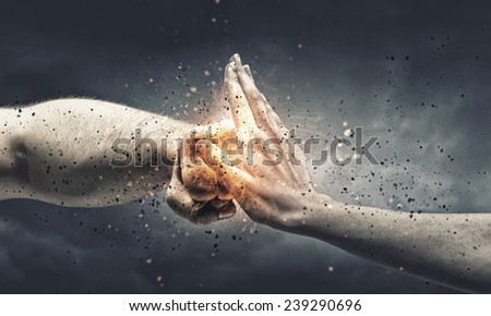 One hand preventing punch attack of another hand