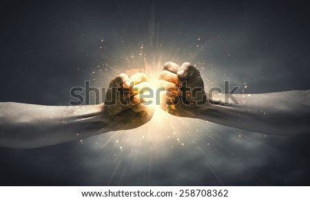 One hand preventing punch attack of another hand