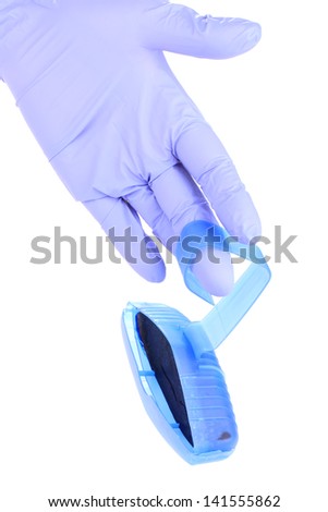 One hand in rubber glove with toilet bowl cleaner