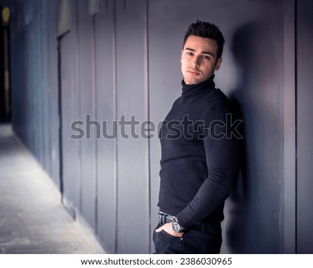 One handsome young man in urban setting in moden city