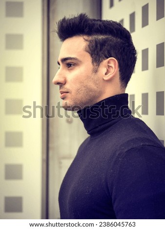 One handsome young man in urban setting in moden city