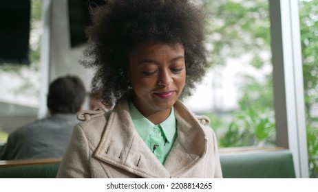 One Happy Black Woman Checking Phone At Coffee Shop. Smiling African American Girl With Afro Hair Reading Cellphone Message