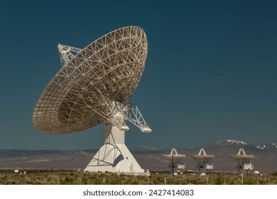 One huge satellite dish and three small dishes.