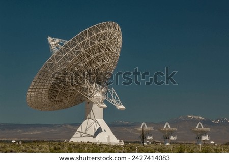 One huge satellite dish and three small dishes.