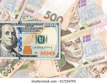 One hundred dollar bill on the background of ukrainian hryvnia