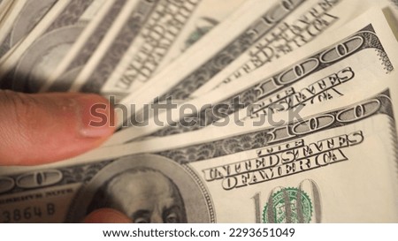 One hundred dollar bills in a man hand