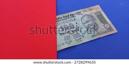 One hundred rupees indian note with red and blue background