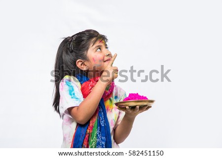 one indian girls celebrating holi with gulal in thali, presenting something, isolated over white background