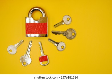 One Key With Red Sticker Among Many Keys Which Is The Same Color Of Padlock , Mistake Proofing Or Poka Yoke Concept As Symbol For Remind To Use The Right Key ,isolated On Yellow Background