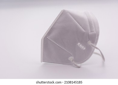 One KN-95 protection medical mask isolated on white background. Prevention of the spread of virus and epidemic, protective mouth filter mask. Diseases, flu, air pollution, coronavirus concept