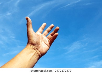 One left hand rise up to bright blue sky and white cloud likey need for something on heaven. - Powered by Shutterstock