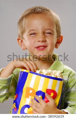 Similar – überraschter Junge mit Popcorn auf blauem Hintergrund