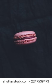 One macaroon on dark background, pink french cookies macaroons - Shutterstock ID 2247539473