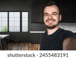 One man 30s adult caucasian male standing at home with a dark hair, bearded and a mustache looking at the camera. Happy smile confident real people