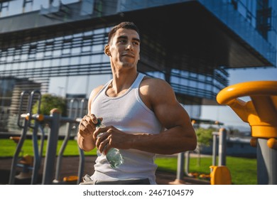 one man caucasian male athlete hold plastic bottle of water opening and prepare to drink while training outdoor in sunny day hydration and healthy lifestyle concept copy space - Powered by Shutterstock