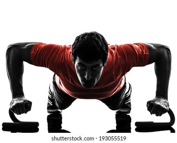 One Man Exercising Fitness Workout Push Ups In Silhouette On White Background