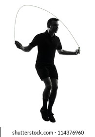 One Man Exercising Jumping Rope  In Studio Silhouette Isolated On White Background