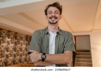 One Man Front View Portrait Waist Up Standing Indoor In Cafe Or Restaurant Lobby Happy Smile Confident Wear Olive Shirt With Modern Haircut Mustaches And Beard Looking To The Camera