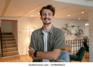 One Man Front View Portrait Waist Up Standing Indoor In Cafe Or Restaurant Lobby Happy Smile Confident Wear Olive Shirt With Modern Haircut Mustaches And Beard Looking To The Camera