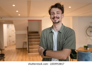 One Man Front View Portrait Waist Up Standing Indoor In Cafe Or Restaurant Lobby Happy Smile Confident Wear Olive Shirt With Modern Haircut Mustaches And Beard Looking To The Camera