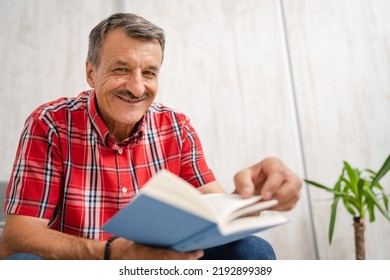 One Man Senior Caucasian Male With Mustaches Read Book At Home Wear Red Shirt Real People Leisure Concept Copy Space Looking To The Camera Happy Smile