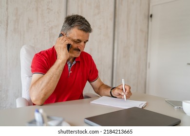 One Man Senior Entrepreneur Active Caucasian Male Making A Phone Call Talking While Sitting At The Desk Table Working At Office Manager And Small Business Real People Copy Space