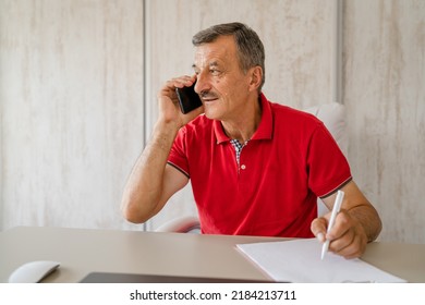 One Man Senior Entrepreneur Active Caucasian Male Making A Phone Call Talking While Sitting At The Desk Table Working At Office Manager And Small Business Real People Copy Space