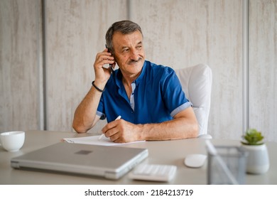 One Man Senior Entrepreneur Active Caucasian Male Making A Phone Call Talking While Sitting At The Desk Table Working At Office Manager And Small Business Real People Copy Space