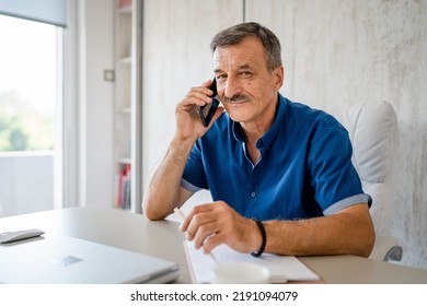 One Man Senior Entrepreneur Active Caucasian Male Making A Phone Call Talking While Sitting At The Desk Table Working At Office Manager And Small Business Real People Copy Space