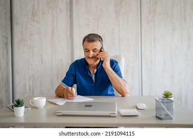 One Man Senior Entrepreneur Active Caucasian Male Making A Phone Call Talking While Sitting At The Desk Table Working At Office Manager And Small Business Real People Copy Space