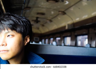 One Man Sit In Japan Old Diesel Train Inside Journey Look Out From Window Sunlight On Face