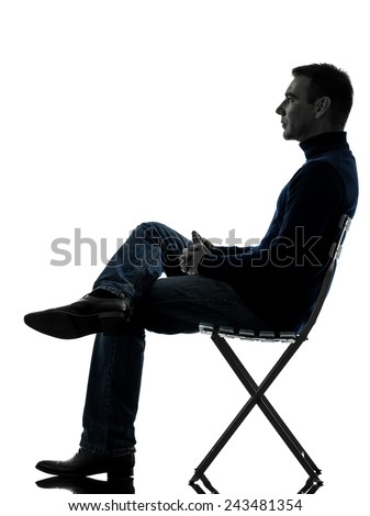 one  man sitting looking up full length in silhouette studio isolated on white background