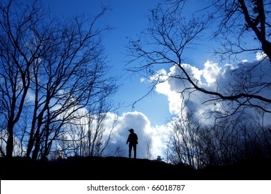 One man stand alone between dry trees