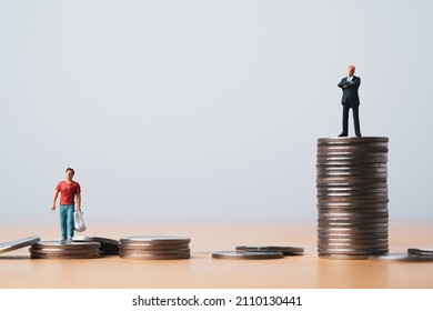 One man standing on higher coins stacking in other man for different salary and unequal income in capitalism country concept.
