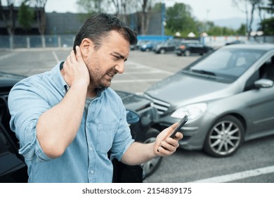 One man suffering pain after car crash injury calling first aid emergency - Shutterstock ID 2154839175