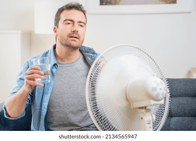 One Man Suffering Summer Heat At Home Trying To Cool Off Drinking Water