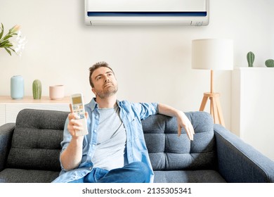 One Man Suffering Summer Heat At Home Trying To Cool Off Using Air Conditioner