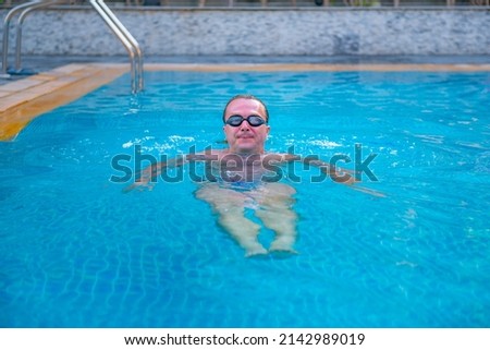 Similar – Ein Mann mit Sonnenhut und einer gelben Gummiente in einem Pool.