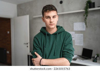 one man teenager stand in room at home wear green hoodie waist up - Shutterstock ID 2261015763
