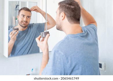 One Man Using Energizing Hair Treatment Cream