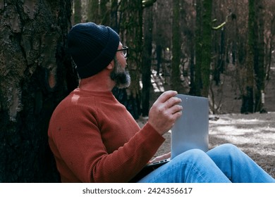One man using technology connection in nature park forest woods. Remote worker small travel business lifestyle people. Working in the nature alternative office. Small business. Travelers job life