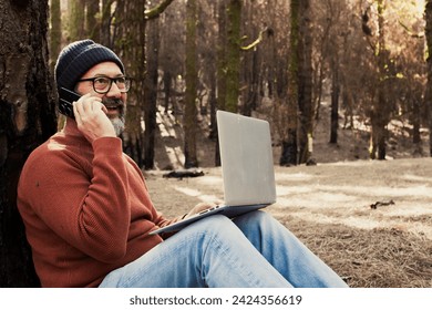 One man using technology connection in nature park forest woods. Remote worker small travel business lifestyle people. Working in the nature alternative office. Small business. Travelers job life