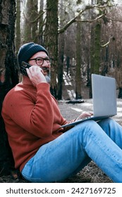 One man using technology connection in nature park forest woods. Remote worker small travel business lifestyle people. Working in the nature alternative office. Small business. Travelers job life