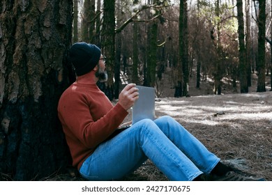 One man using technology connection in nature park forest woods. Remote worker small travel business lifestyle people. Working in the nature alternative office. Small business. Travelers job life